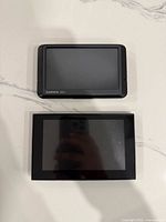 Front view of both GPS units showing screens; Garmin Nuvi top, Android GPS bottom