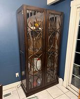 Front view of Hooker dark wood glass door display cabinet showing decorative glass panels