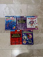 Front covers of five middle school workbooks