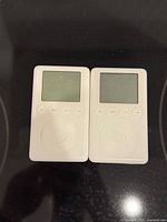 Front view of both iPods showing screens, control buttons and scroll wheels