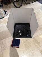 Photo light tent with lamps and folded backdrops