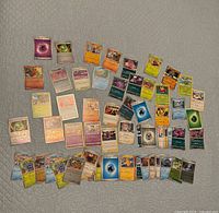 Top-down view of spread of Pokemon cards showing variety of card types and finishes