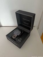 Watch in open Van Heusen box showing full bracelet and dial