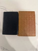 Closed black leather Bible beside brown slipcase