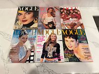 Six Vogue magazines laid out
