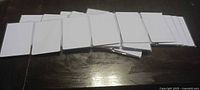 Stacked white blank NFC cards displayed on a dark surface