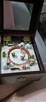 Music box open showing winter scene and mirror