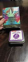 Front of Potheads Against Sanity box and Sagittarius trivia tin