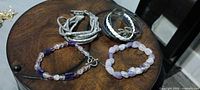 All four bracelets arranged on tabletop