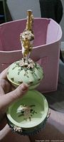 Music box open showing carousel horse topper and interior floral design