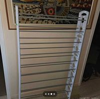 Full view of disassembled shoe rack showing side frame and metal bars