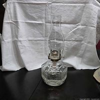 Full view of pressed glass oil lamp with chimney