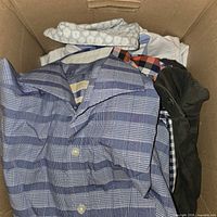 Box containing multiple folded men’s shirts