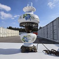 Full view of milk glass floral lamp showing base, midsection, shade, chimney and power cord