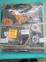 Packaged set showing banner, balloons, picture display pieces and tape rolls