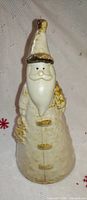 Front view of cone-shaped ceramic Santa with gold accents