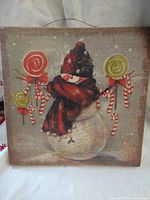 Front of canvas showing snowman scene with lollipops