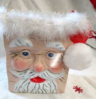 Front view of ceramic Santa treat bag showing face, fur trim, pom-pom