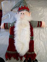 Front view of elf hand puppet showing beard, outfit and bells