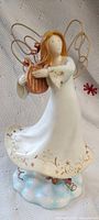 Front view of angel figurine holding harp