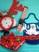 Group shot of all four pet accessories on teal background