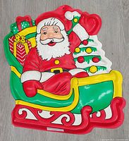 Front view of multicolour molded plastic Santa in sleigh decoration