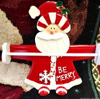 Front view showing full Santa design, dowel rod and "Be Merry" text