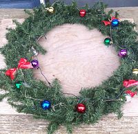 Full view of 30" artificial wreath with ornaments, bows, bead garland and lights