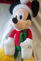 Front view of large Mickey Mouse plush wearing festive attire