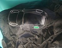 Black nylon tire cover with printed car outline