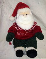 Front view of Santa plush doll with red sweater reading HOHO, green pants, hat, and boots