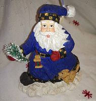Full view of Santa figurine showing colors, accessories and puppy detail
