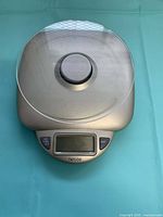 Front view of Taylor digital kitchen scale showing platform, buttons and display