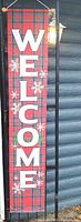 Full view of vertical plaid WELCOME banner hanging