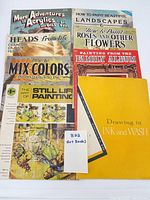 All eight art instruction books laid out