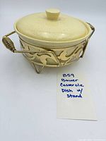 casserole with lid in metal stand, front view