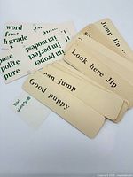 pile of beige and white word cards showing various words and phrases