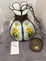 Full view of hanging lamp with chain and canopy