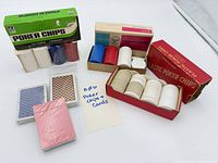 Overview of two boxes of poker chips and three decks of cards