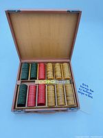 Overall view of open wooden case showing chips and dice