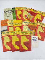 All 14 maps laid out, showing county map covers and two larger regional maps