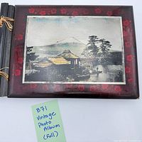 Front cover showing red floral design and landscape print