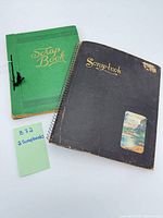 Front covers of both scrapbooks with lot note