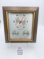 Full view of framed Westclox weather center standing on easel