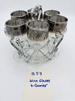 Set of six silver-rimmed wine glasses in carrier front view