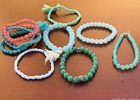 Group shot of all ten bracelets arranged on surface