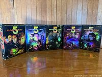 Front view of all five Babylon 5 DVD season box sets lined up