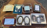 All eight picture frames displayed on table