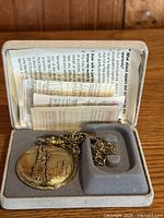 Pocket watch in presentation box with paperwork visible