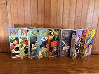 Front spines of all eight VHS tapes lined up